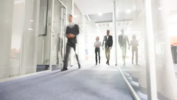People walking through office