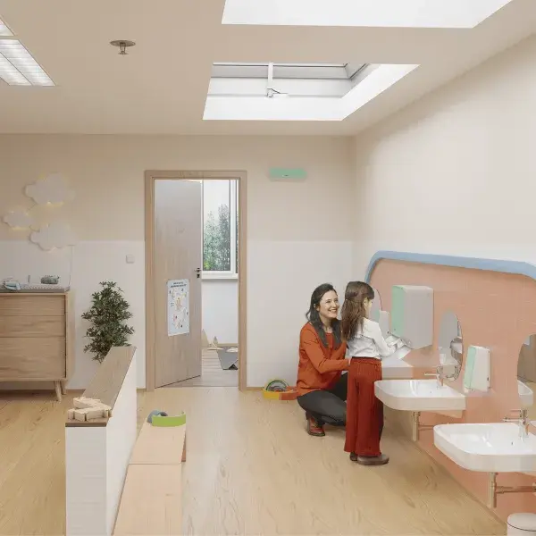 Teacher and child washing hands in elementary school